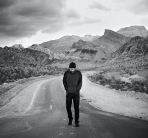 black and white man walking in the middle of the road