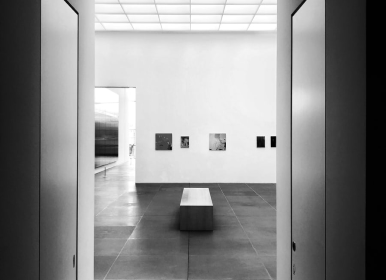 black and white photo of a bench in a gallery