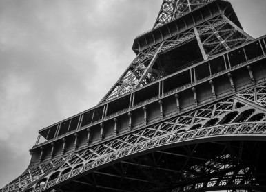 black and white photo of Eiffel Tower taken from the ground up