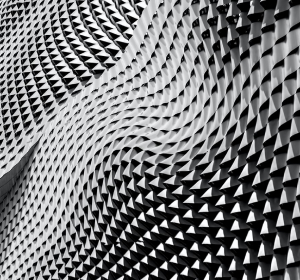 black and white photo of wave in the structure of a building